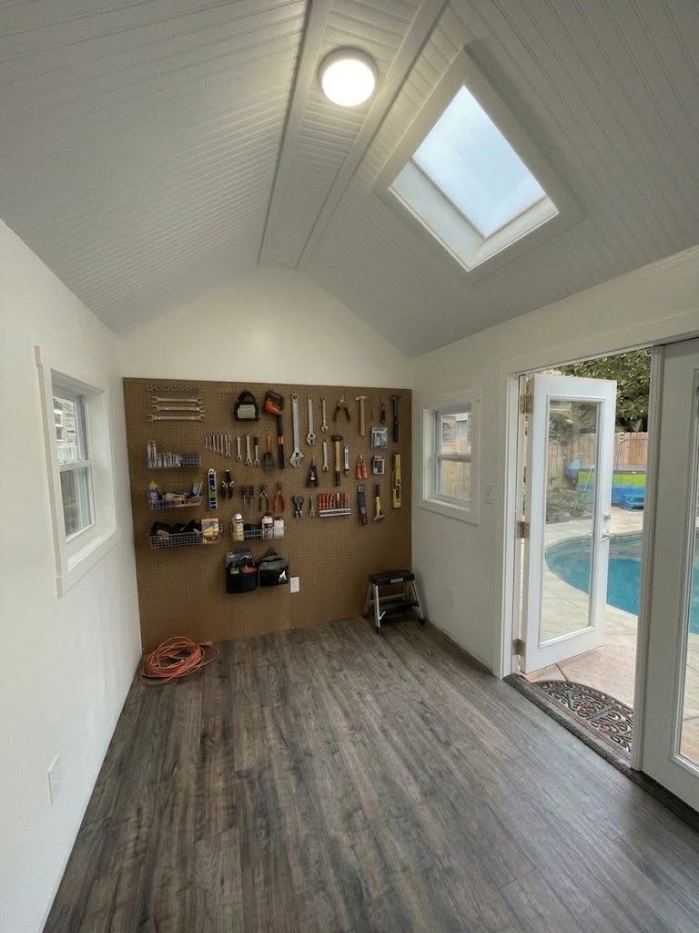 Silver interior with pegboard tool wall and LVP flooring
